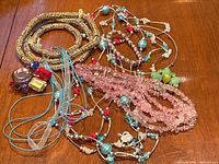 Photo of assorted colorful 1980s and 1990s costume jewellery consisting of various beaded necklaces and bracelets, including handmade glass beads.