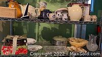 Two photos showing metal shelves holding a variety of crocks, pottery, creamers, sugar jars, crystal dishware, and decorative bowls arranged across two shelves.
