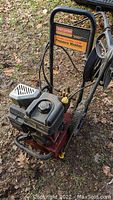 Front view of Craftsman gas pressure washer showing motor, frame, and hose