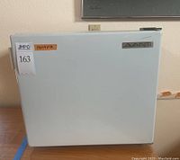 White Avanti mini fridge front with brand logo and measurements label.