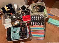 Overhead view of four bins filled with assorted bags and pouches on carpeted floor