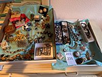 Wide view of assorted jewelry pieces on turquoise cloth