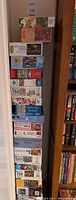 Stacked boxes of assorted jigsaw puzzles showing brands and partial puzzle images