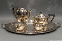 Complete 5-piece tea service set displayed on the serving tray showing coffee pot, teapot, sugar bowl, and creamer.