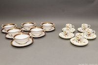 Six Spode Copeland cream soup bowls and saucers arranged with five Royal Worcester Roanoke demitasse cups and saucers