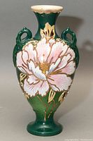 Front view of the antique hand painted Satsuma vase, showing detailed floral artwork and ornate handles.