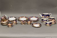 Full view of Royal Albert and Osborne dishes including luncheon plates, dessert plates, teacups, saucers, teapot, sugar bowl, creamers, and square plates.