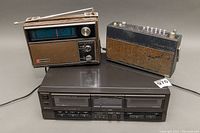 Overview of the three items showing the Technics cassette deck on bottom and two radios on top: Telefunken Partner 306 (left) and Juliette (right)