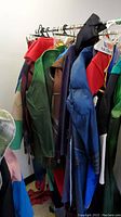 Costumes hanging on a rack visible from the side, showcasing various colors and styles.