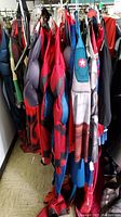 Side view of Marvel adult-sized costumes assorted on hangers on a rack.