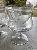 Close-up photo showing the clear shrimp cocktail glass with visible Cornflower engraving on the bowl, part of the set of three glasses.
