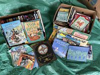 Photo of multiple boxes of children's books with various colorful covers showing several titles spread out.