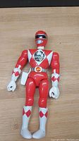 Front view of the 1994 Bandai Red Ranger action figure showing detailed red and white pattern, helmet, and articulated limbs.