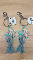 Photo of two identical Jar Jar Binks keychains with original Star Wars tags, showing the full front view on a wooden background.