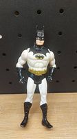 Front view of the vintage 1990 Batman figure showing the black and white suit, yellow belt, and bat emblem on chest.