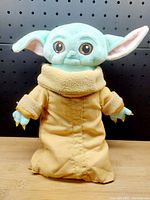 Front of 12 inch Yoda/Grogu plush showing face, ears, and robe front