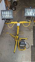 Full view of the floor standing double drywalling light with the smaller single light on the floor behind it