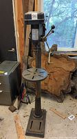 Front view of floor drill press showing head, column, base and table