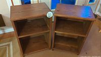 Pair of two wooden bedside tables side by side, showing their front and overall shape and size.