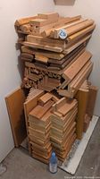 Front view of stacked oak wood pieces of various profiles