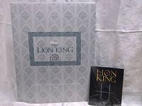 Boxed set showing large lithograph and a smaller booklet or certificate.