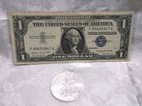 Photo showing front of 1957A Silver Certificate one dollar bill with serial number P99650947A and a 2011 Silver Eagle coin below it.