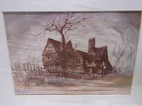 Photo of matted print featuring a large old wooden house with multiple gables, barren trees, and a fence in muted brown and gray tones, signed by Allen Hawks.