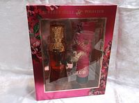 Front view of Beverly Hills Polo Club gift set box showing the eau de parfum bottle and body lotion tube through clear window with floral design on packaging.