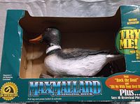 Max Mallard Singing Duck figurine in original cardboard packaging, showing branding and callout to sound features.