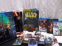 View of Star Wars DVDs, action figures, Topps 20th Anniversary magazine, and trading cards.