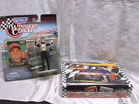 Bobby Labonte figurine in original Winner's Circle packaging next to sealed Texaco Havoline trading cards box