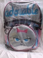 Front view of backpack and lunchbag packaged in plastic, showing the character face on the front pocket and 'YES, I'M THIS adorable' text.