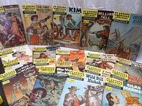 Overview photo of 20 Classics Illustrated vintage comic books arranged side by side, titles visible, showing their colorful illustrated covers and condition.