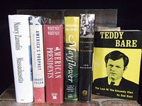 Seven hardcover history books standing upright on a shelf. Visible titles include Massachusetts, America's Prophet, American Presidents, Mayflower, Franklin and Winston, and Teddy Bare.