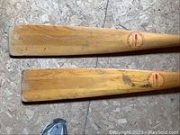 Close-up of oar blades showing manufacturer logo and wear marks