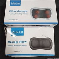 Photo showing two Renpho pillow massager boxes with packaging damage.