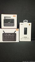 Three factory packaged Bluetooth audio devices: two 1Mii B03 transmitters/receivers and one Fiio BTR3K headphone amplifier.