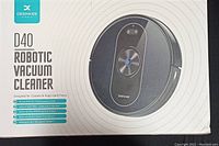 Box of Deenkee D40 robotic vacuum cleaner showing brand, model, and key features