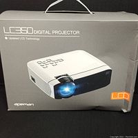 Photo showing Apeman LC350 Digital Projector in its original packaging with image of the projector and LCD logo.