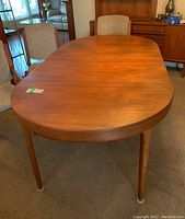 Full view of oval tabletop and tapered legs