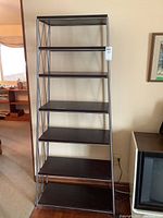 Full front view of shelving unit showing six shelves and metal frame