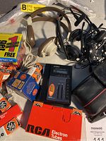 Photo showing several boxes of RCA and GE electron tubes along with beige headphones, black headphones, and AIWA cassette player.
