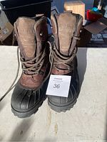 Front view of the pair of L.L. Bean boots showing brown leather and textile material with rubber toe cap and sole, size 11 indicated by the seller.