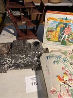 Photo of the lot showing the marble writing set, wooden tiered shelf, vintage tin biscuit box, and Asian panels.