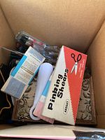 Box containing Ardsee pinking shears in original box and other sewing items in fabric bag.