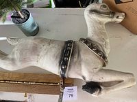 Side view of the vintage Beco reindeer figure showing body and partial legs with metal harness and visible cracks