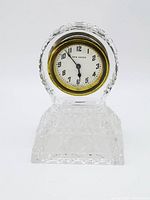Full front view of the antique New Haven desk clock with cut crystal base and clock face visible