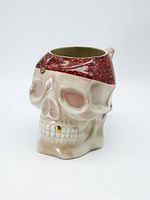 Front side view of the ceramic skull mug showing facial and bandana details