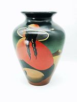 Image of large Peruvian pottery vase showing hand painted folk art scene with figure in red clothing and large brimmed hat.