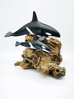 Side angle view of the orca whale mother and calf sculpture on burlwood base showing size relation and detail.